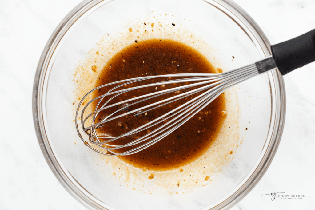 marinade for watermelon steaks in a bowl with a whisk.
