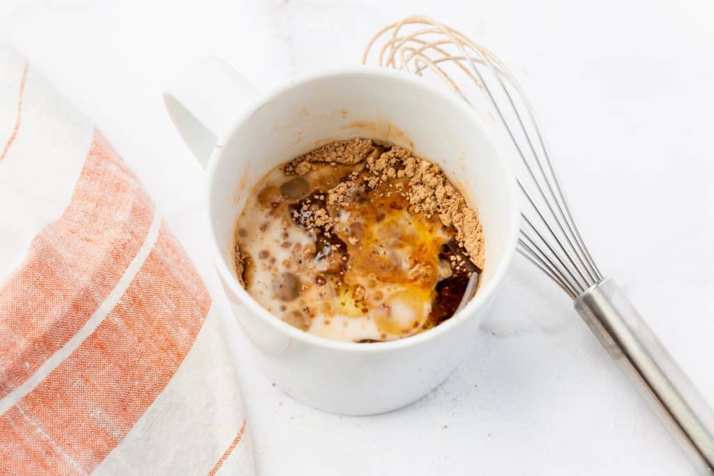 Ingredients for protein mug cake in a mug.
