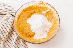 Powdered sugar added to pumpkin dip