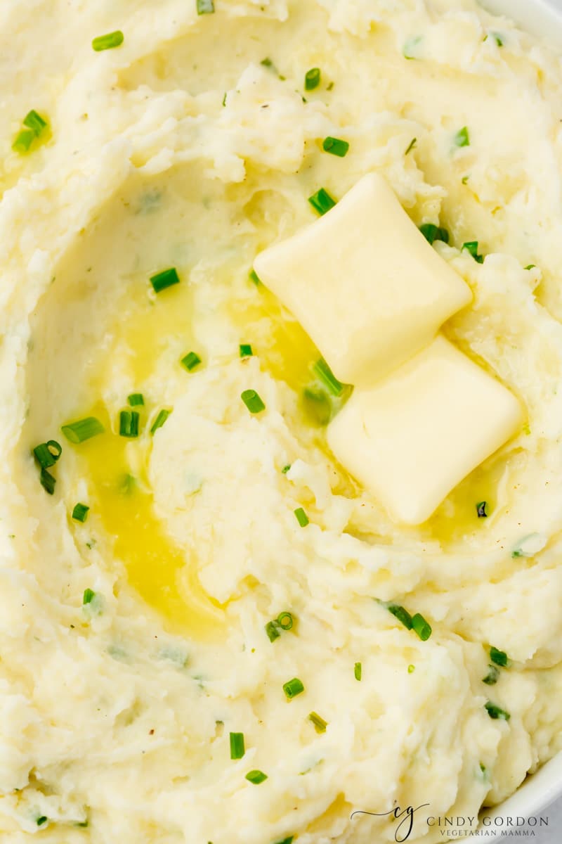 closeup shot of creamy ranch mashed potatoes with chives and butter