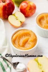 Place in white cup for serving. Pictured with apples and a spoon.