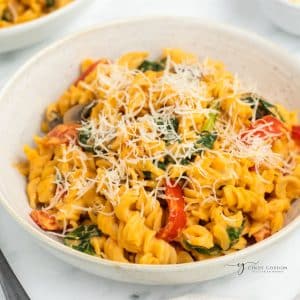 a bowl of fusilli with sweet potato sauce