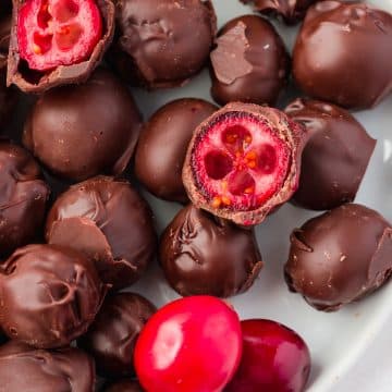 closeup of a plate filled with chocolate covered cranberries.