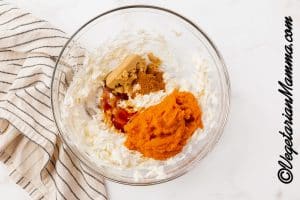 Add pumpkin puree, pumpkin spice, vanilla to the cream cheese.
