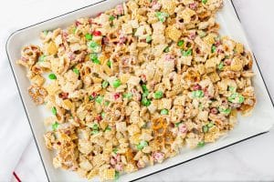 White chocolate chex mix spread onto a sheet pan.