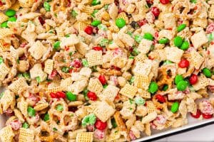 Closeup view of white chocolate chex mix with extra sprinkles and candy.