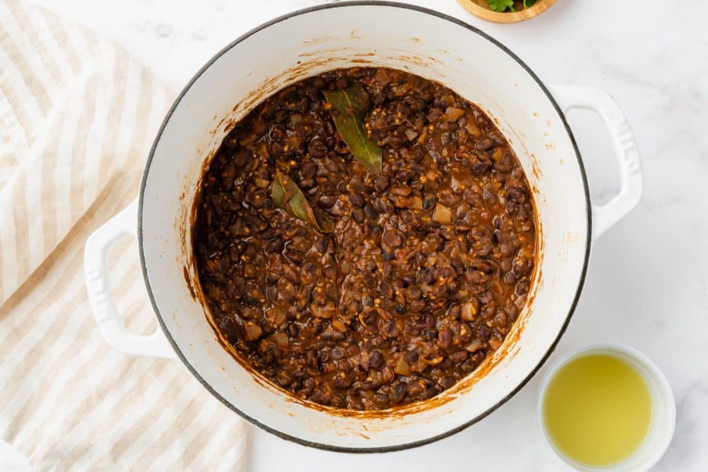 seasoned black beans that have finished cooking. They are in a thick sauce.