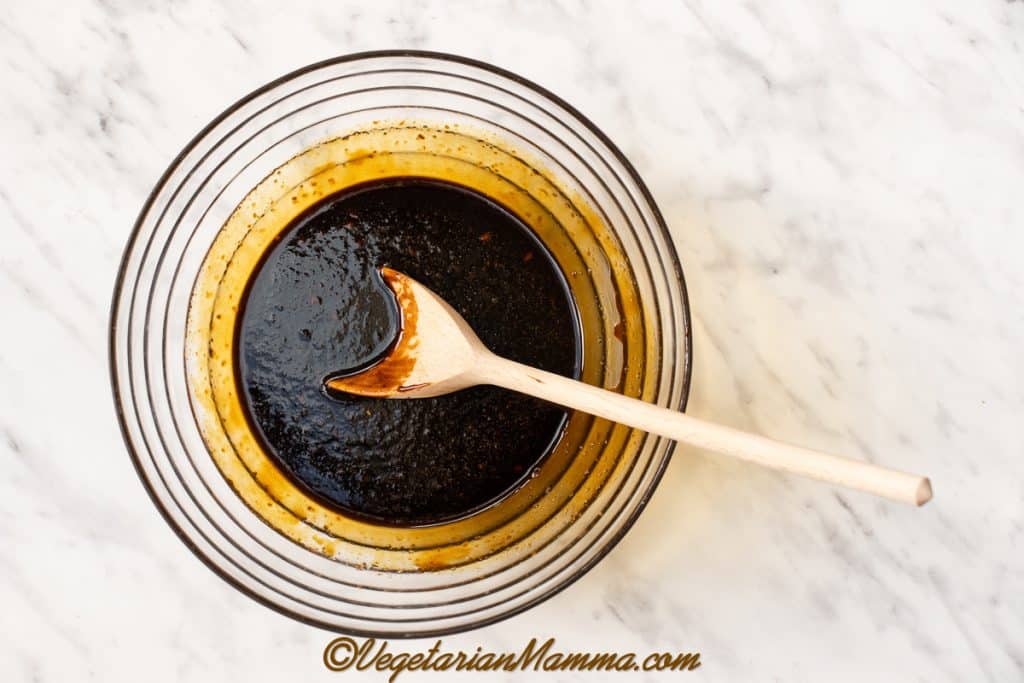 Once melted, transfer to a large mixing bowl. Add the flax egg and vanilla extract. Beat with a wooden spoon until well combined.