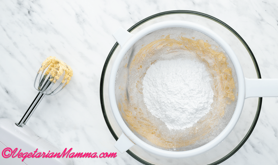 Gradually sieve in the powdered sugar a little at a time, whisking after each addition until incorporated.