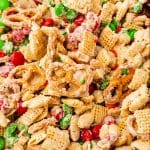 White Chocolate Chex Mix with red and green M&Ms, pretzels, and chex squres.