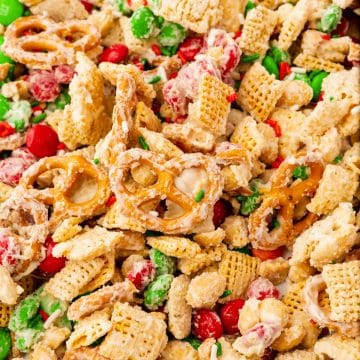 White Chocolate Chex Mix with red and green M&Ms, pretzels, and chex squres.