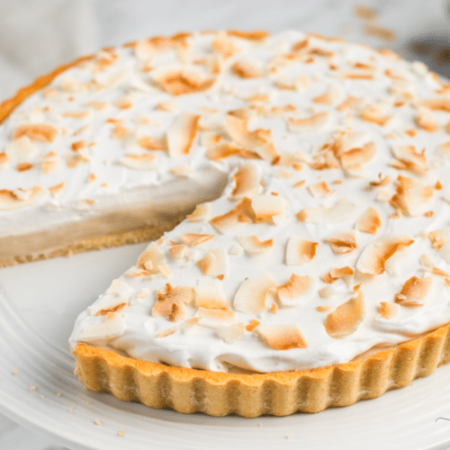 coconut cream pie topped with toasted shredded coconut.