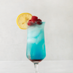 Grateful Dead Drink, in a tall clear glass. Red liquid on bottom, most of the liquid is blue and ice cubes in it. Lemon wheel and raspberries on top