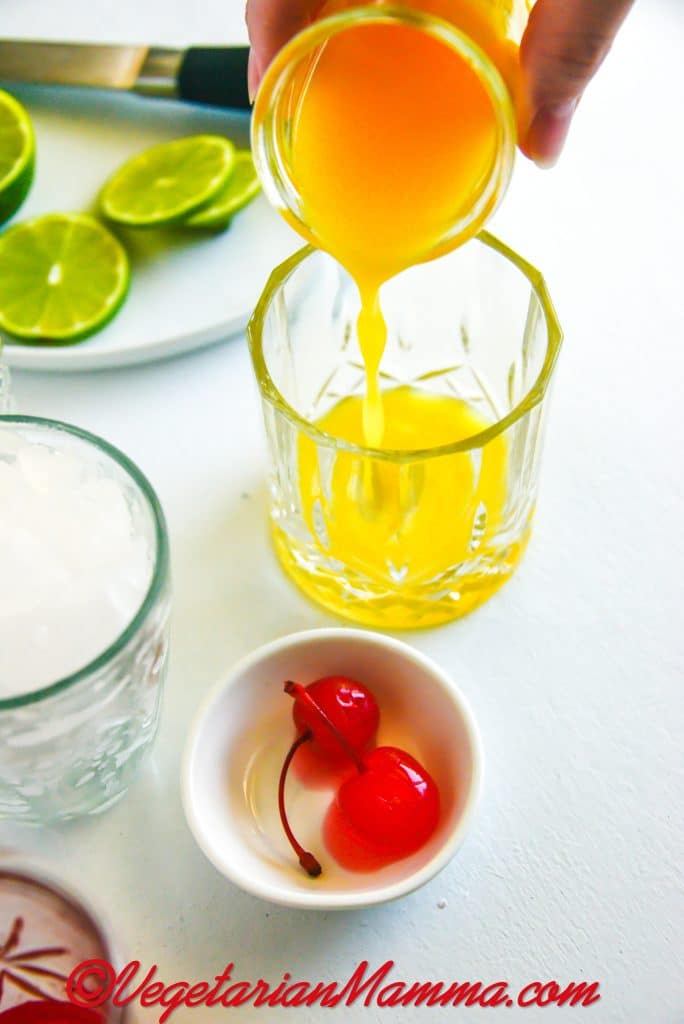 Add the orange juice/pineapple juice blend to your glass. (We use a rocks glass)