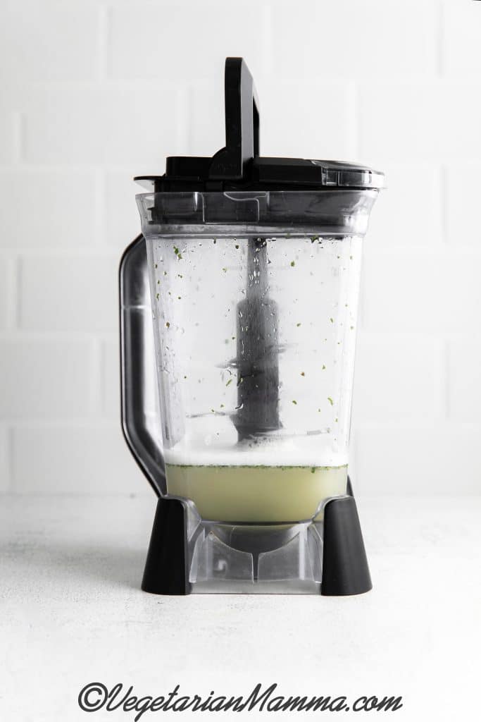 Blender with juice and mint leaves