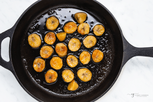 a cast iron frying pan with caramelized bananas.