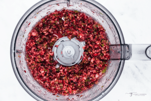 a food processor holding chopped cranberries with jalapeno