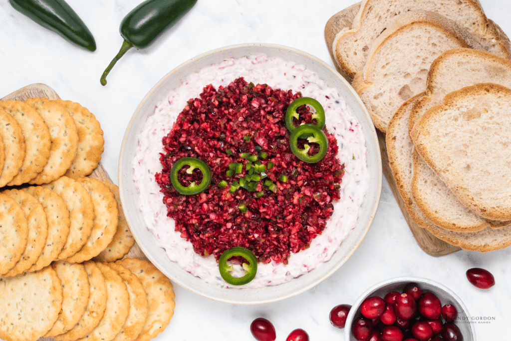 Finished cranberry jalapeno dip in a bowl, topped with diced jalapenos.