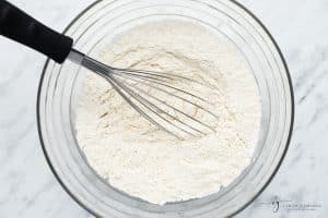 flour in a bowl with a whisk.