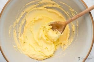 butter, creamed in a bowl with a wooden spoon.