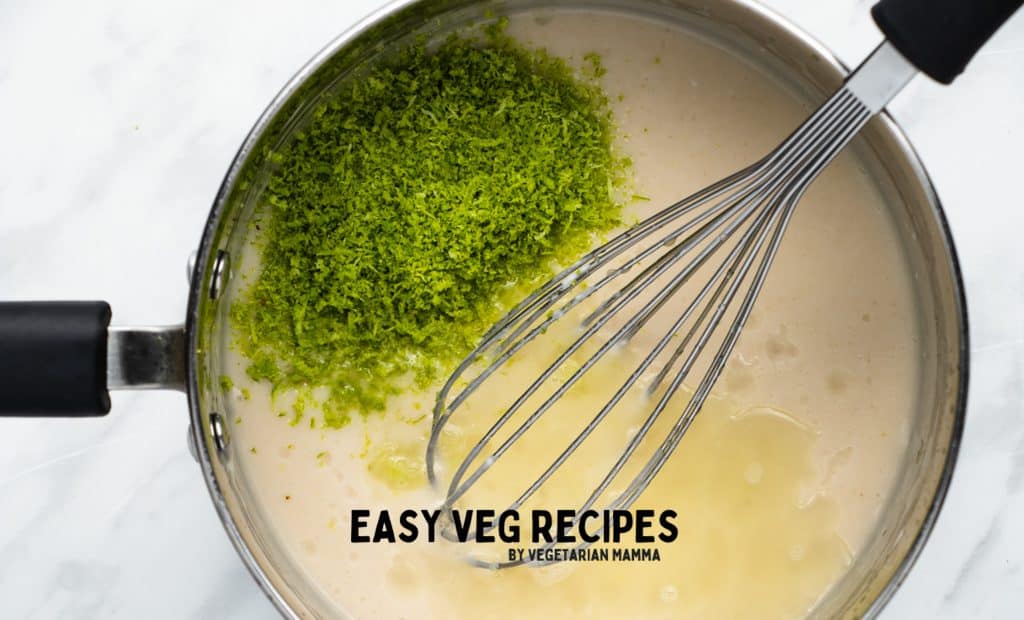 vegan key lime filling in a saucepan, lime juice and zest being stirred in.