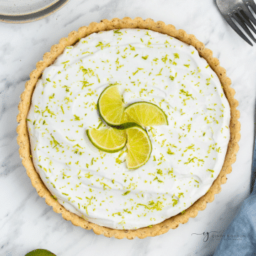 top down view of a whole key lime pie in a tart crust.