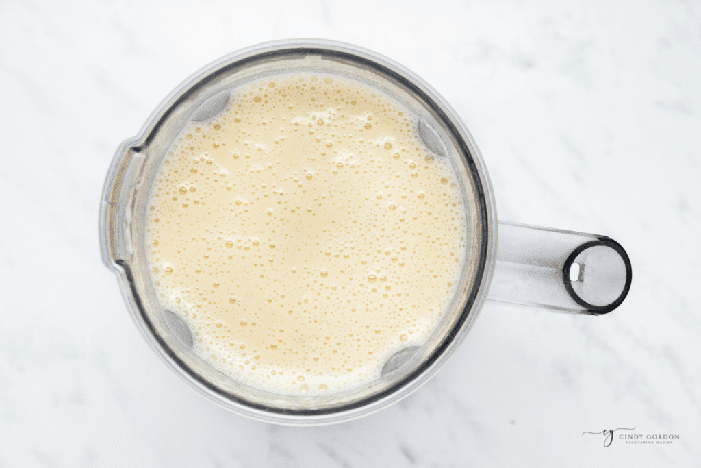a blender holding pureed potato soup