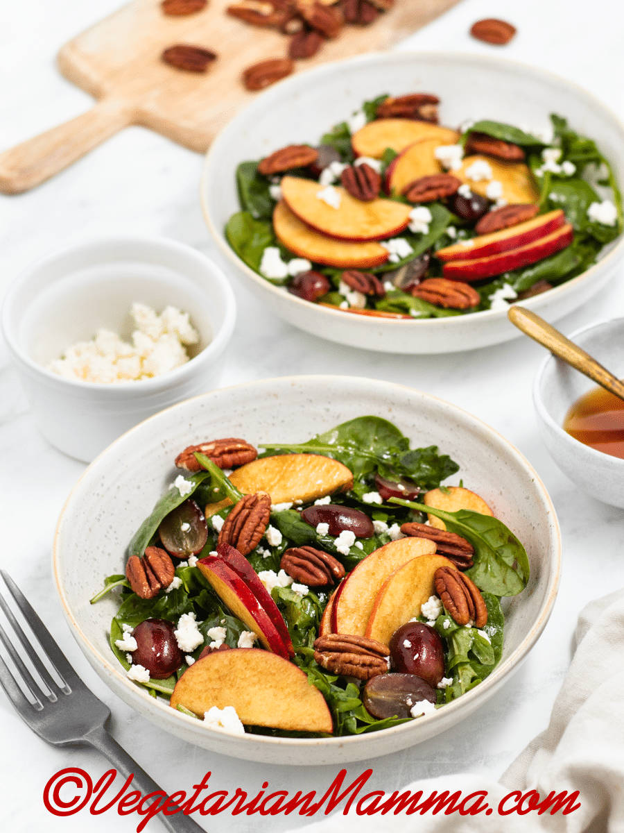 Two servings of apple pecan salad on a table. 