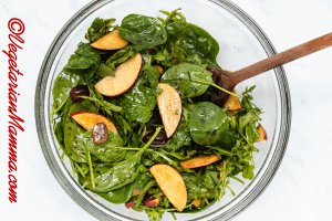 Add grapes, apples, spinach, and arugula to a bowl.