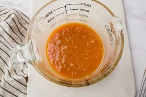 microwave caramel sauce in a glass measuring cup