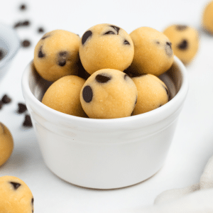 a ramekin filled with edible chocolate chip cookie dough bites.