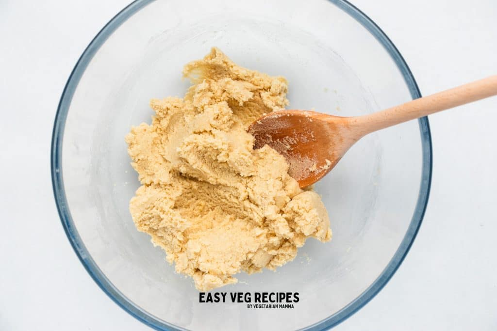 a glass bowl with almond flour cookie dough.