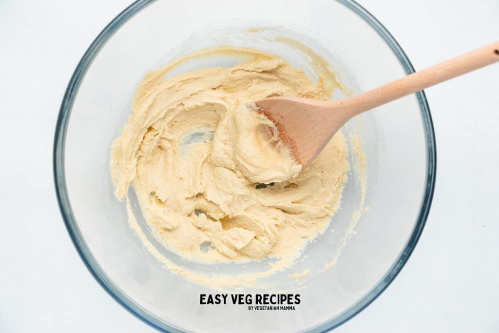 butter and sugars creamed together in a glass mixing bowl