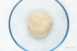 a ball of fresh tortilla dough in a glass bowl