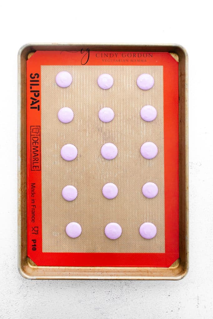 macaron shells piped onto a silpat