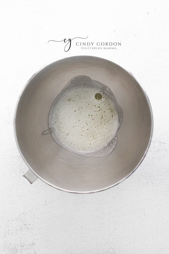 whipped egg whites in a metal mixing bowl