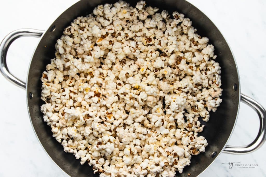 a pot holding freshly popped popcorn.