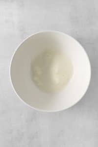 a white bowl with whipped egg whites