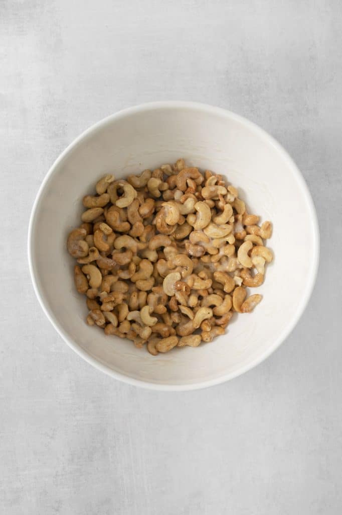 a mixing bowl filled with whole cashews.