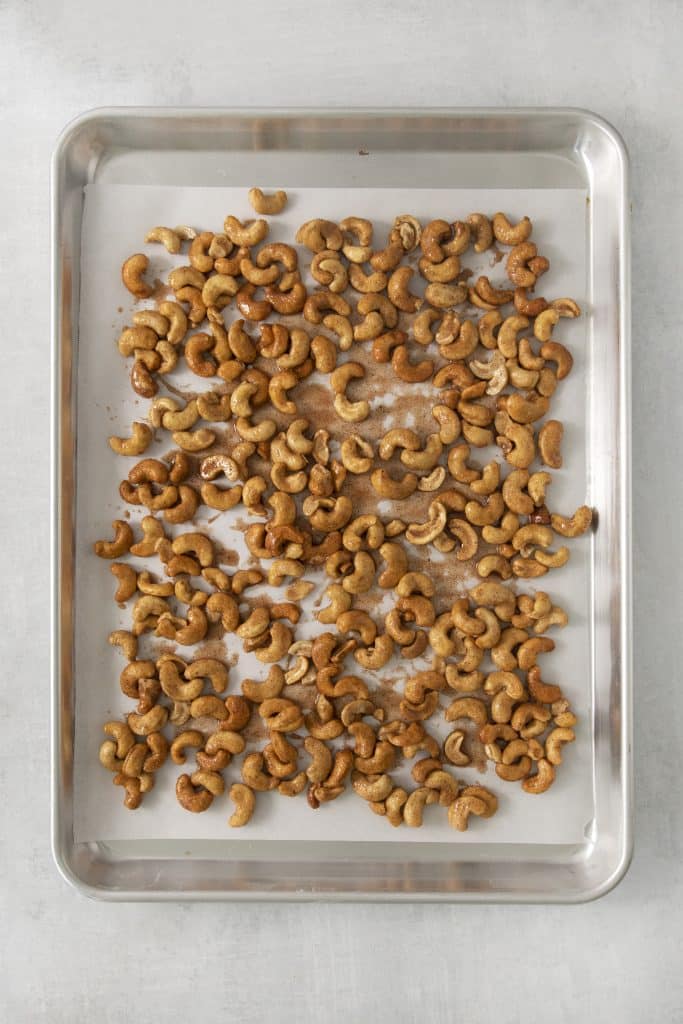 candied cashews on a sheet pan, before baking.