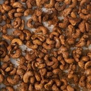 closeup of toasted candied cashews on a pan.