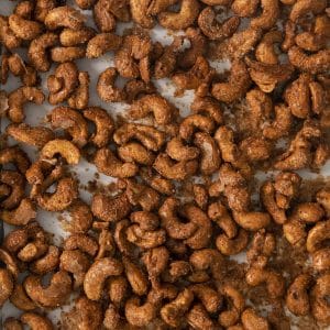 closeup of toasted candied cashews on a pan.