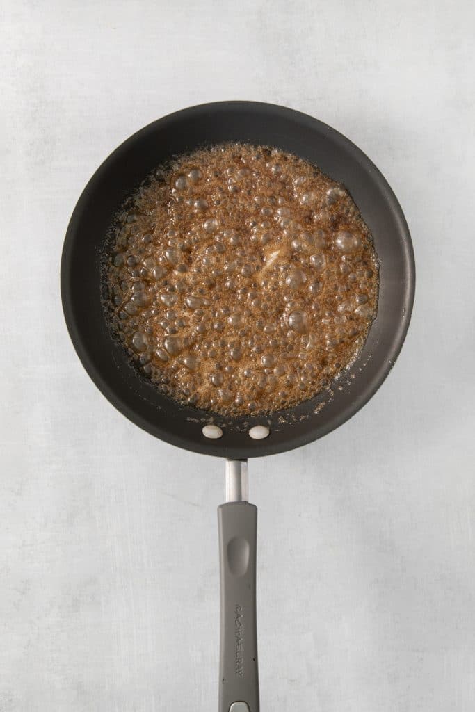 caramel for candied pecans in a skillet.