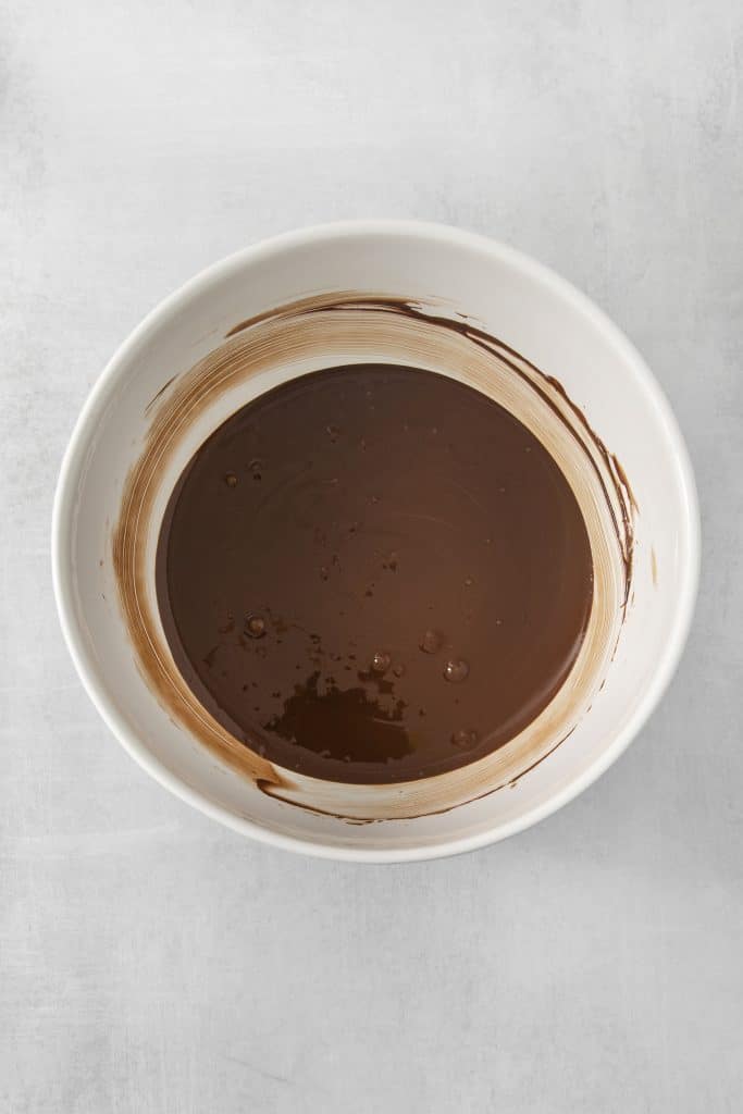 melted chocolate and peanut butter in a white bowl.