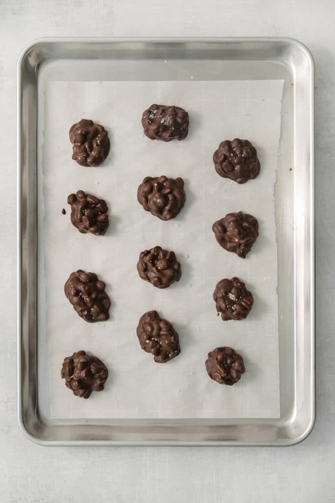 peanut candy made into clusters on a baking sheet.