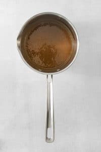 cooked caramel sauce in a silver saucepan