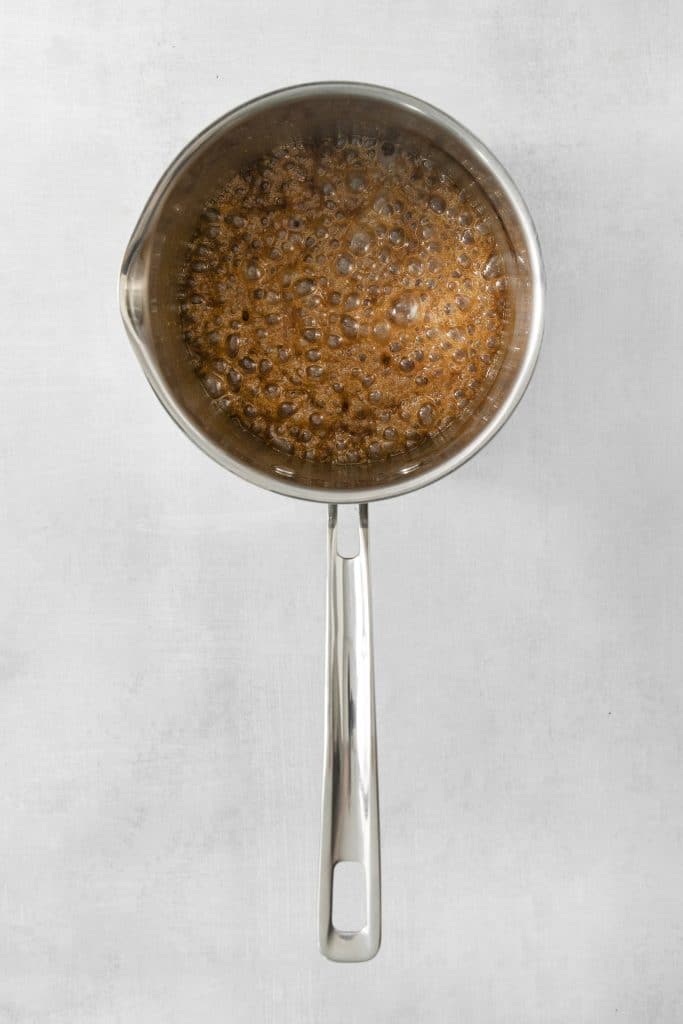 caramel sauce bubbling in a saucepan, viewed from overhead