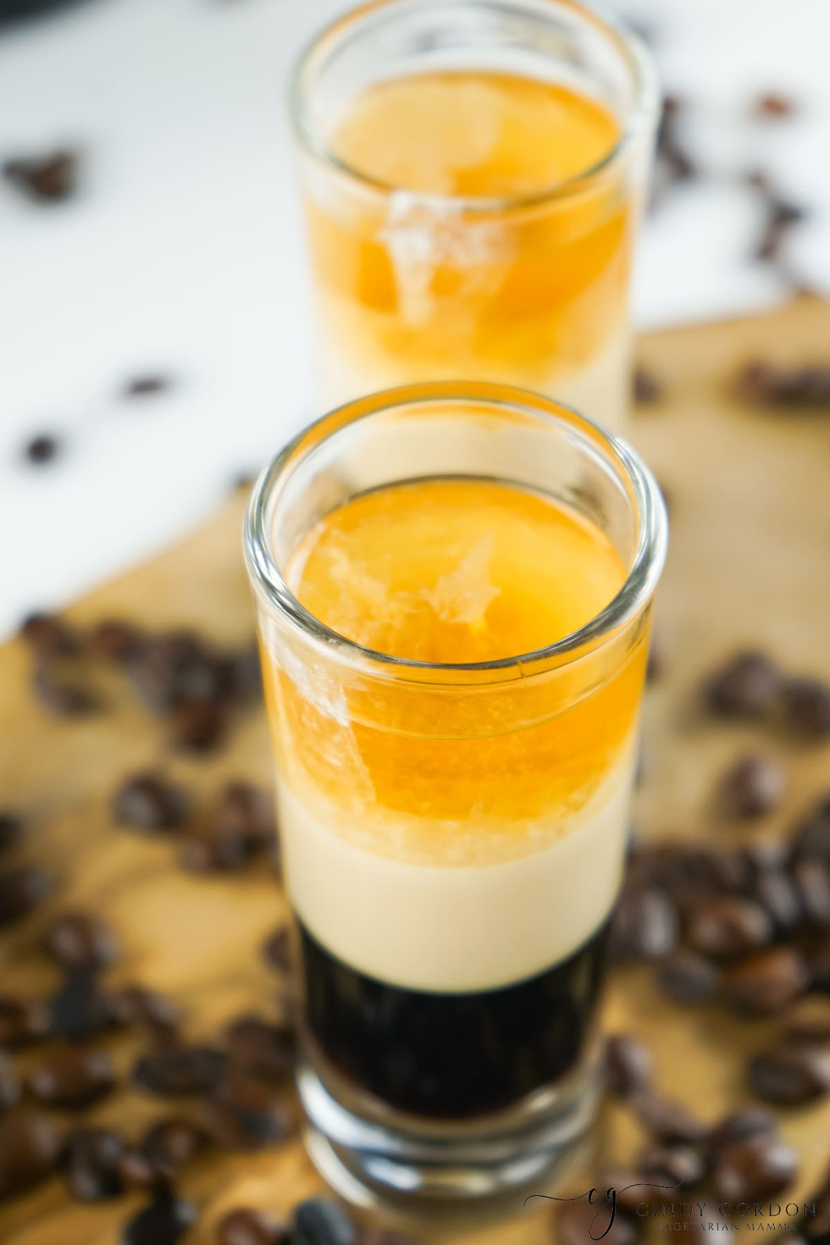 a tall shot glass filled with a layered duck fart shot with whiskey, baileys, and kahlua