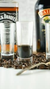 a shot glass filled ⅓ of the way with coffee liqueur