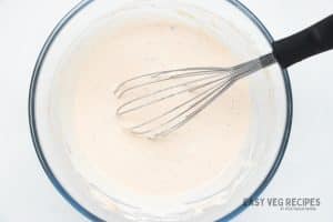 Sour cream dip whisked in a large glass bowl